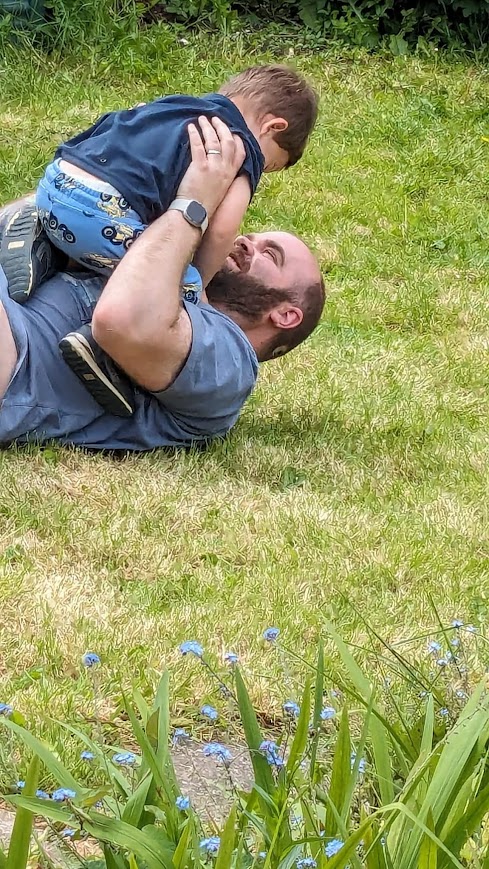 Ronan playing with his son in the garden